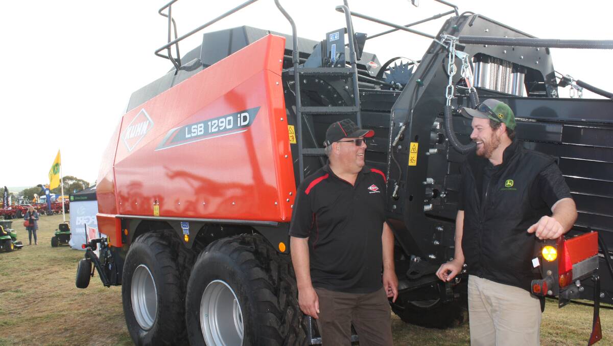 Kuhn WA territory manager Clive French (left) and AFGRI Equipment Moora branch manager John Schreurs discuss the features of the new Kuhn LSB 1290 iD large square baler at the recent McIntosh & Son Mingenew Midwest Expo.