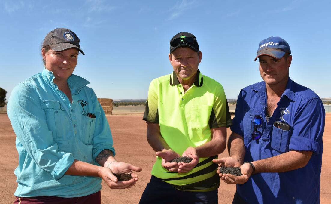 Jeff Edwards (centre), daughter Chloe and son-in-law Ben Stockton with Carbon Ag's WA Broadacre Blend compost and new carbon granule product for seeding applications at the family's 'Brooklands' property east of Brookton.