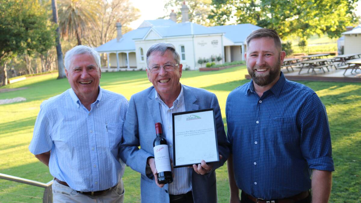 FMIA executive officer John Henchy (left) and chairman Brad Forrester (right) presented Farm Weekly senior journalist Ken Wilson with a "good bottle of red" and certificate to acknowledge his years of service to their association and WA agriculture.