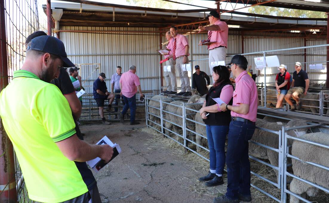 The Elders team in full swing during the Merredin Breeders Ram Sale, with auctioneer Wayne Manoni on the rail (centre) having a few laughs with the crowd as he sought to push for the best price. 