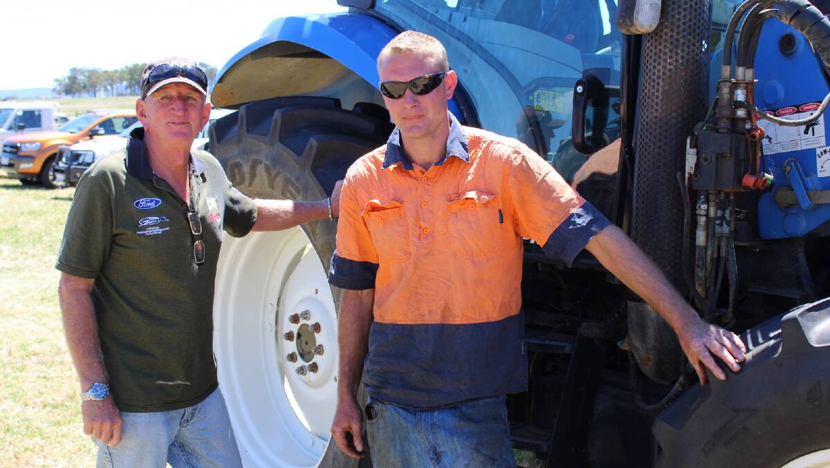 Dace Verbakel (left), Scotsdale and Sam Howell, Narrikup, having a look over one of the tractors at the Woodwards' clearing sale.