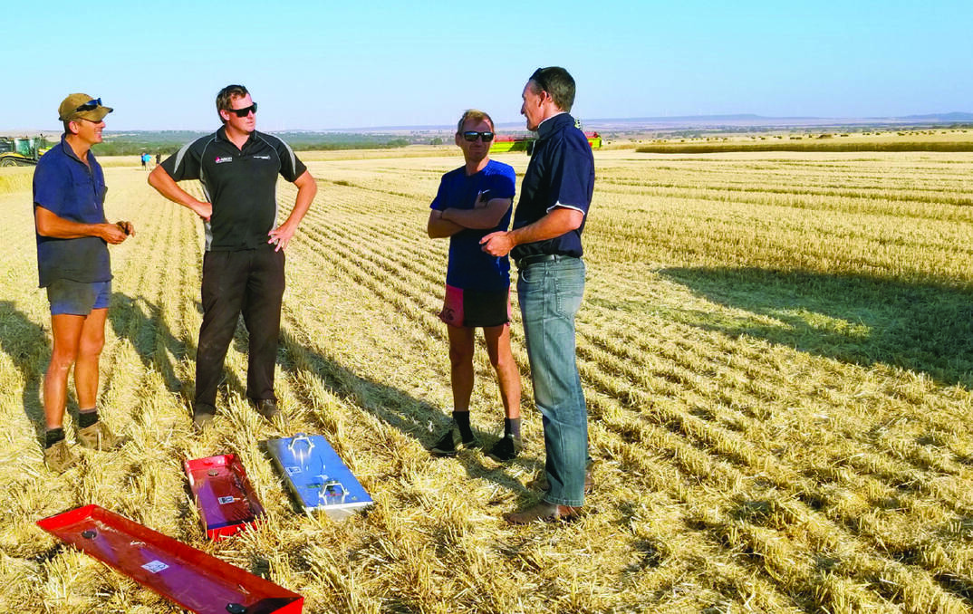 Australian Herbicide Resistance Initiative (AHRI) communications consultant and Planfarm advisor Peter Newman (right) discussing the importance of measuring harvest loss.