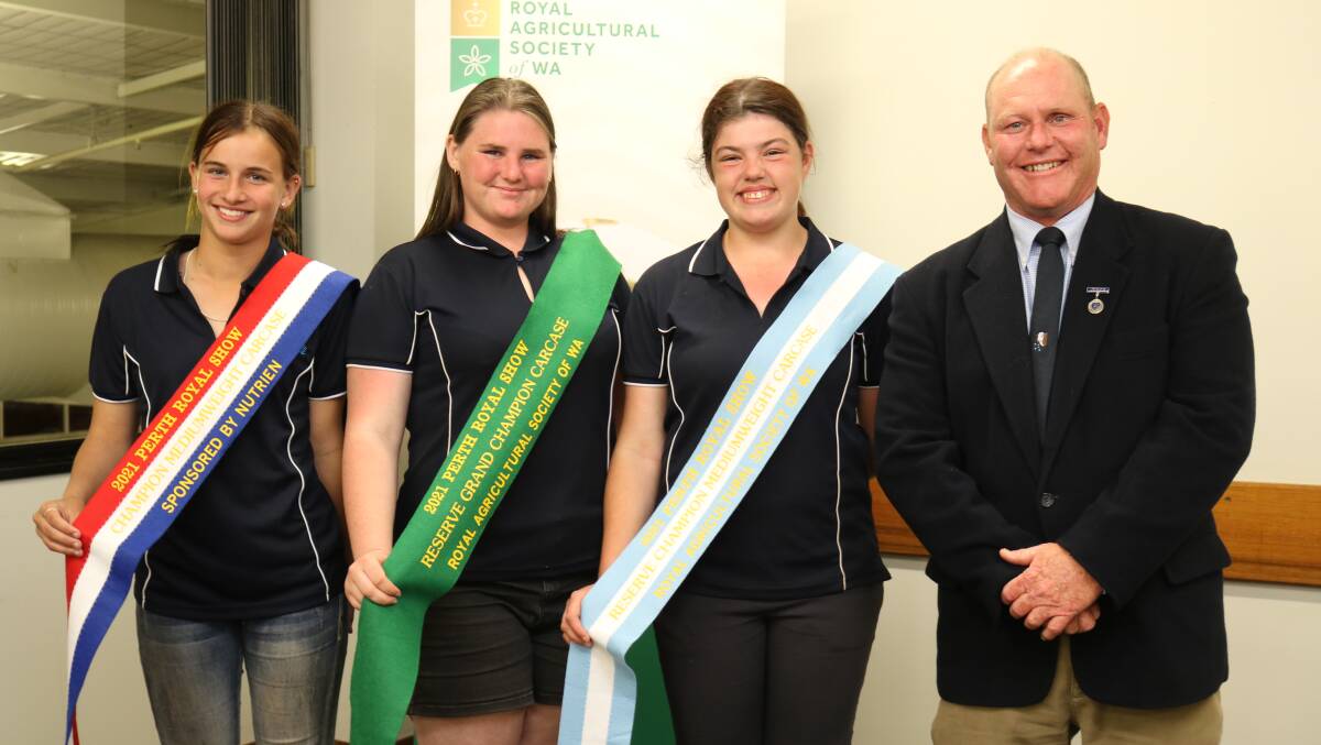 Kelmscott Senior High School brought 12 led steers and heifers and went home with ribbons for reserve grand champion carcase, champion mediumweight carcase and reserve champion mediumweight carcase held by students Laine Macpherson (left), Bunbury, Janissa Martin, Ballajura and Chloe Pears, Margaret River, with Peter Cowcher, Williams, representing sponsor Nutrien Livestock.