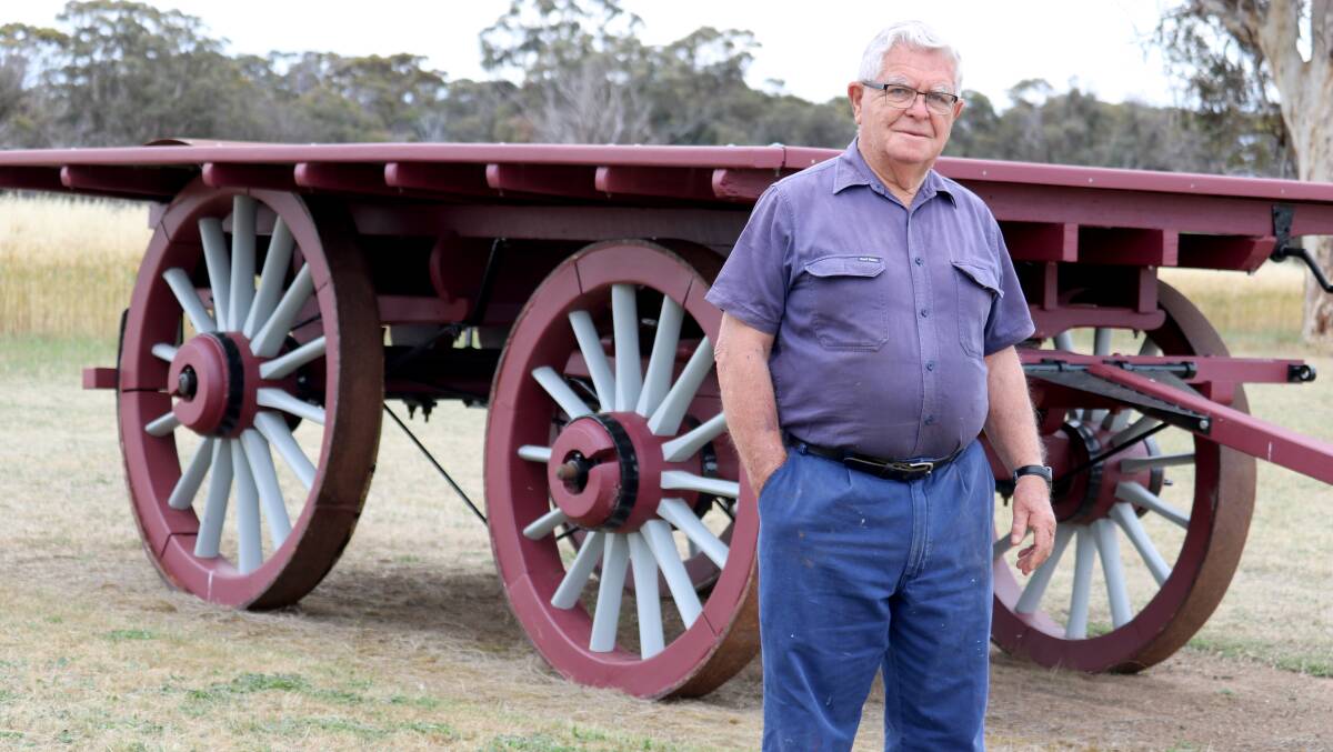 Neville Garlick stands in front of one of his restored wagons on his property near Katanning.
