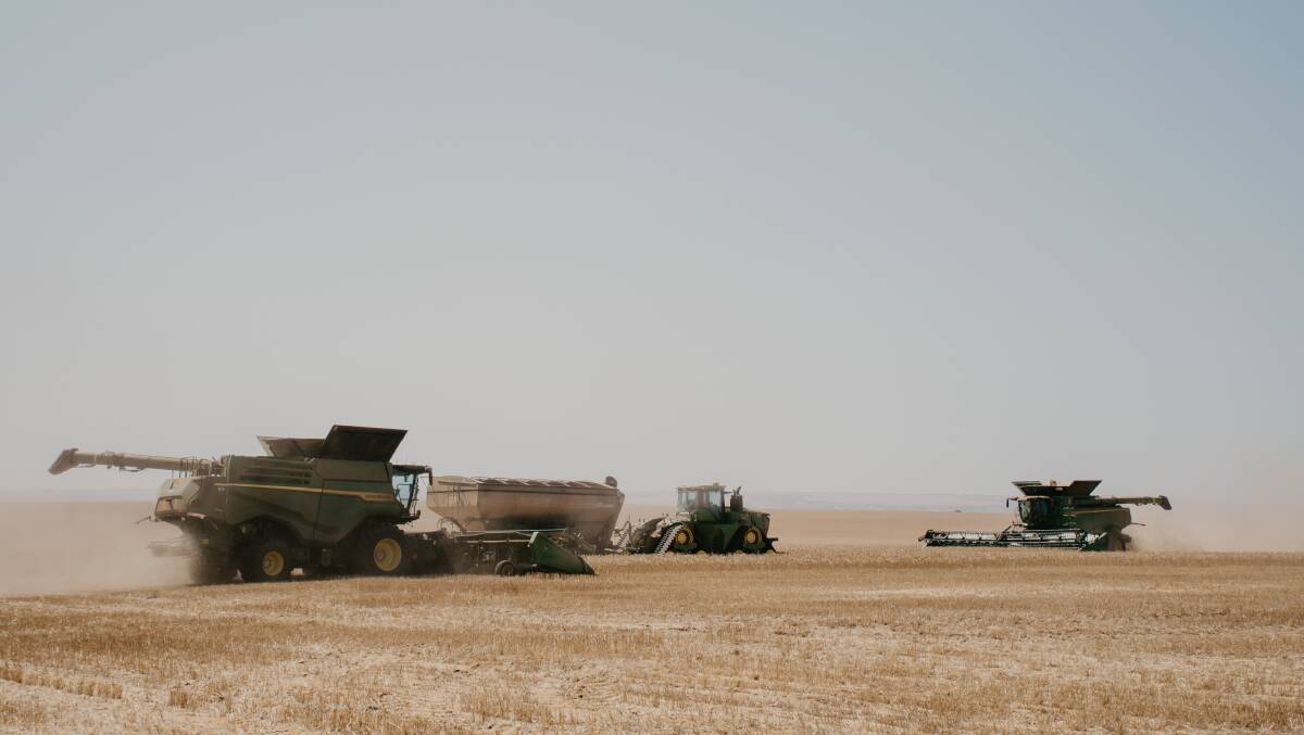 Some of the four John Deere harvesters in action in one of the final wheat paddocks. Photo by Amy Schultz Photography.