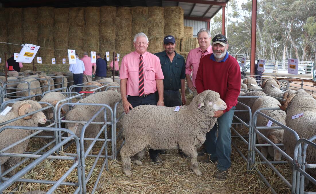 Repeat buyer Wayne Haeusler (second left), WG Haeusler, Wannamal, paid $1500 for the top-priced Poll Merino ram. With him are Elders auctioneer Deane Allan (left) and Mildlands livestock agent Geoff Shipp (second right) with Mallibee co-principal Roger Glover.