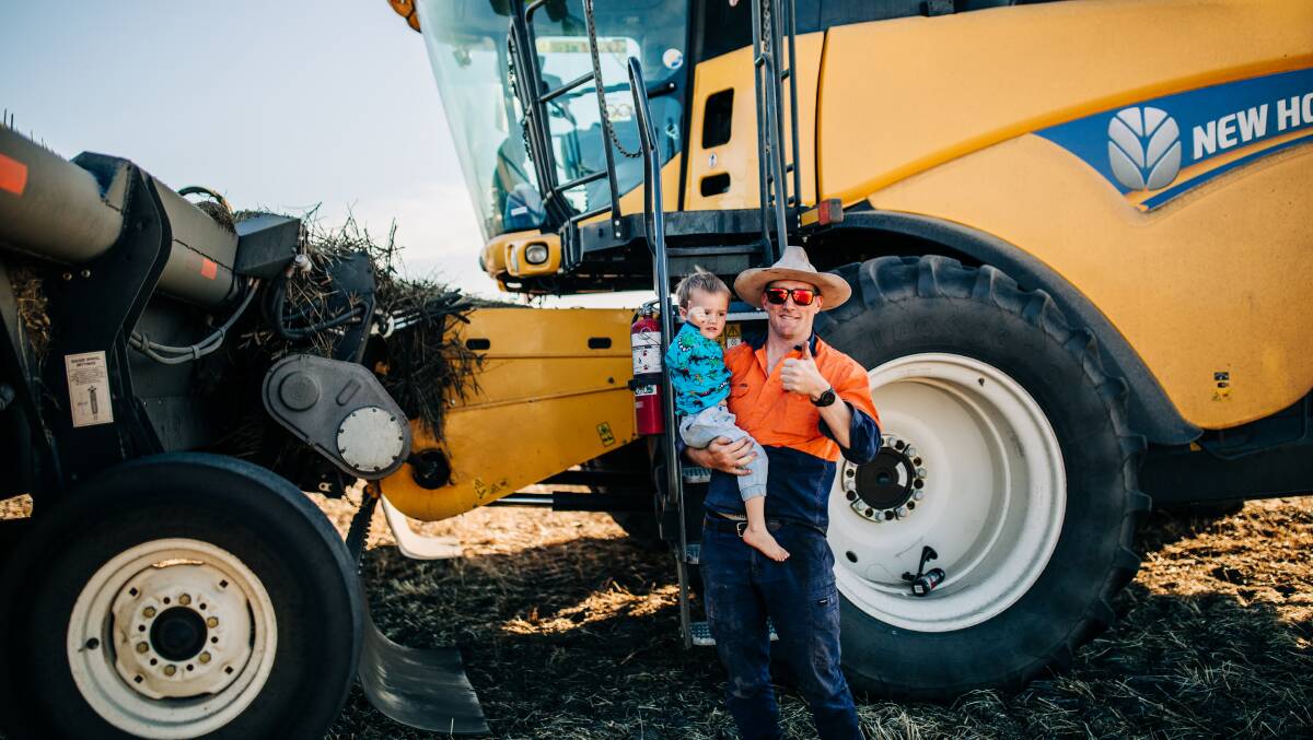 Chase, 3, and his dad Ashley Grylls taking a break from harvest at Bulyee. Photo by Jackie Grylls, Bulyee (@thefarmerswifelife).