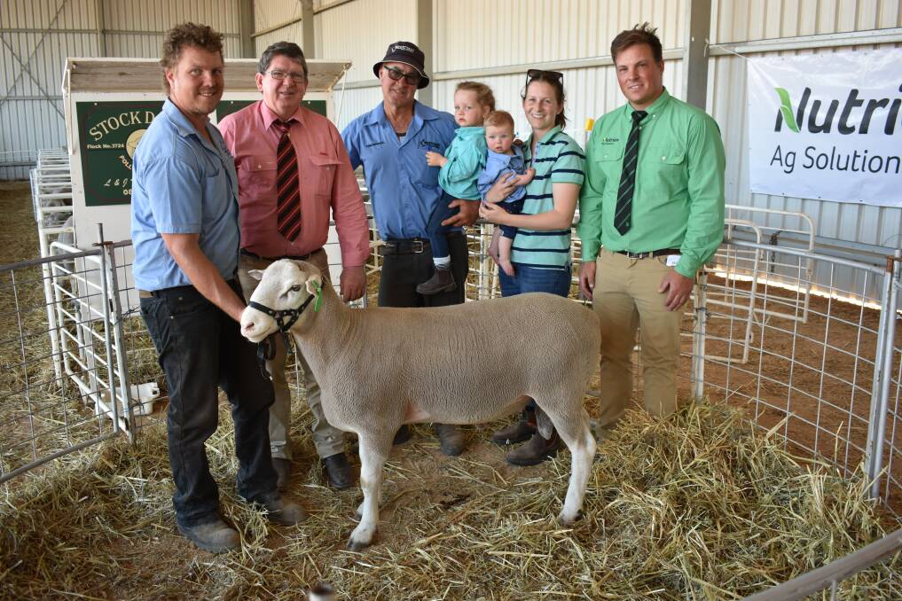 This $5100 top-priced Poll Dorset ram sold to Tim Stevenson, Jolma stud, Cunderdin. Holding the ram is Stockdale co-principal Brenton Fairclough (left), Elders stud stock prime lamb specialist Michael O'Neill, Mark Fairclough with Brenton and Belwyn's daughter Piper Fairclough, Belwyn Fairclough with son Harry Fairclough, eight months and Nutrien Livestock, York, Beverley and Quairading agent Denis Warnick.