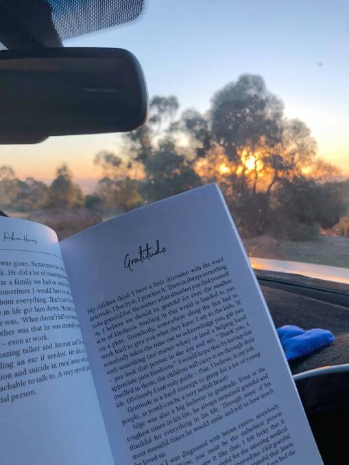 A reader sent this photograph with the following message, "Hello Robina. I've just stolen a little time to myself (in the car at a lookout) and reading your book".