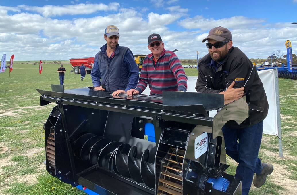 Chris Helliwell (left), and Matt Helliwell, Maya, flank Darkan farmer and inventor Ray Harrington while checking out a Harrington Seed Destructor.