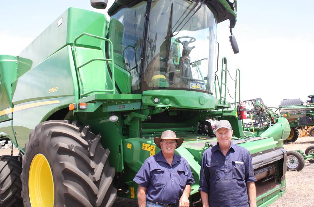  Retired Grass Patch farmer Tony Ietto (left) and Haydn Thomas, Scaddan, in front of a John Deere S680 combine harvester which achieved the sale top price of $415,000. With 600 engine hours and 470 rotor hours, it was considered a good buy. It came with a 12.2 metre 640D front and RTK guidance. 