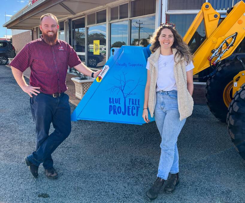 Mr Elliott with Blue Tree Project chief executive officer and founder Kendall Whyte and the special blue bucket fitted to a JCB Telehandler to raise awareness of mental health issues. Boekeman Machinery, Wongan Hills, donated $2500 from the sale to a local farmer of the telehandler and blue bucket, to the Blue Tree Project.