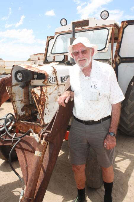 Former farmer Philip Surtees checks out this David Brown 1212 tractor which later sold for $1000 to a Yerecoin collector. Mr Surtees is the father of vendor Catherine Brennan.
