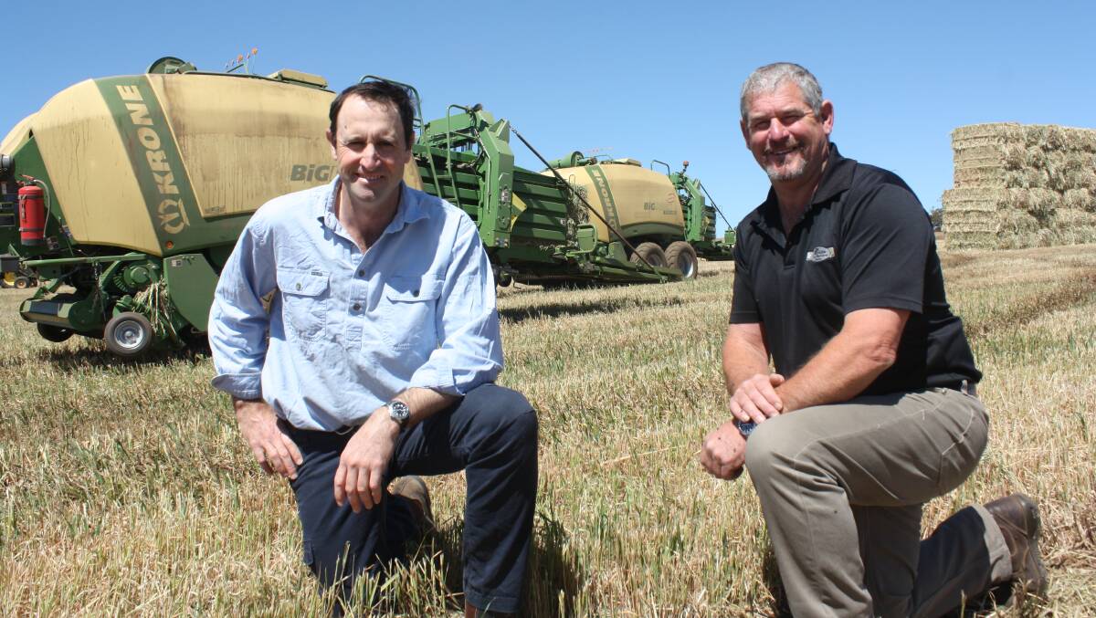 Williams hay producer Mark Fowler (left) and Perkins Farm Machinery Centre, Narrogin, sales manager Brad Langford, in front of Mr Fowler's two Krone 1290HDP-HS large square balers which will finish a 1850 hectare program next week having formed more than 12,000 bales.