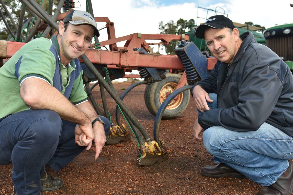  Williams and Harrismith grower Mark Fowler (left) and Damon Fleay, SACOA, take a closer look at the family's sowing kit set-up for delivery of the SE14 soil moisture agent at seeding. INSET: SE14, together with trace elements and fungicide, is banded with seed and compound fertiliser at the back of paired-row boots.