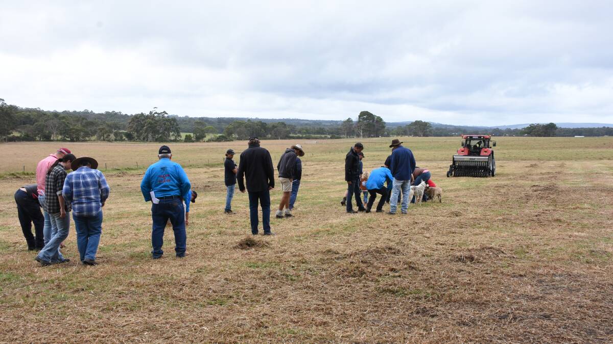  Field day delegates watching and inspecting the results from the Direct Seeding demonstration.