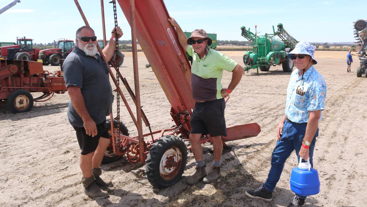 George Bolt (left) and Murray Edwards, both of Wagin and Dick Marshall, Narrogin, had a look at this hay loader while taking the time to catch up.