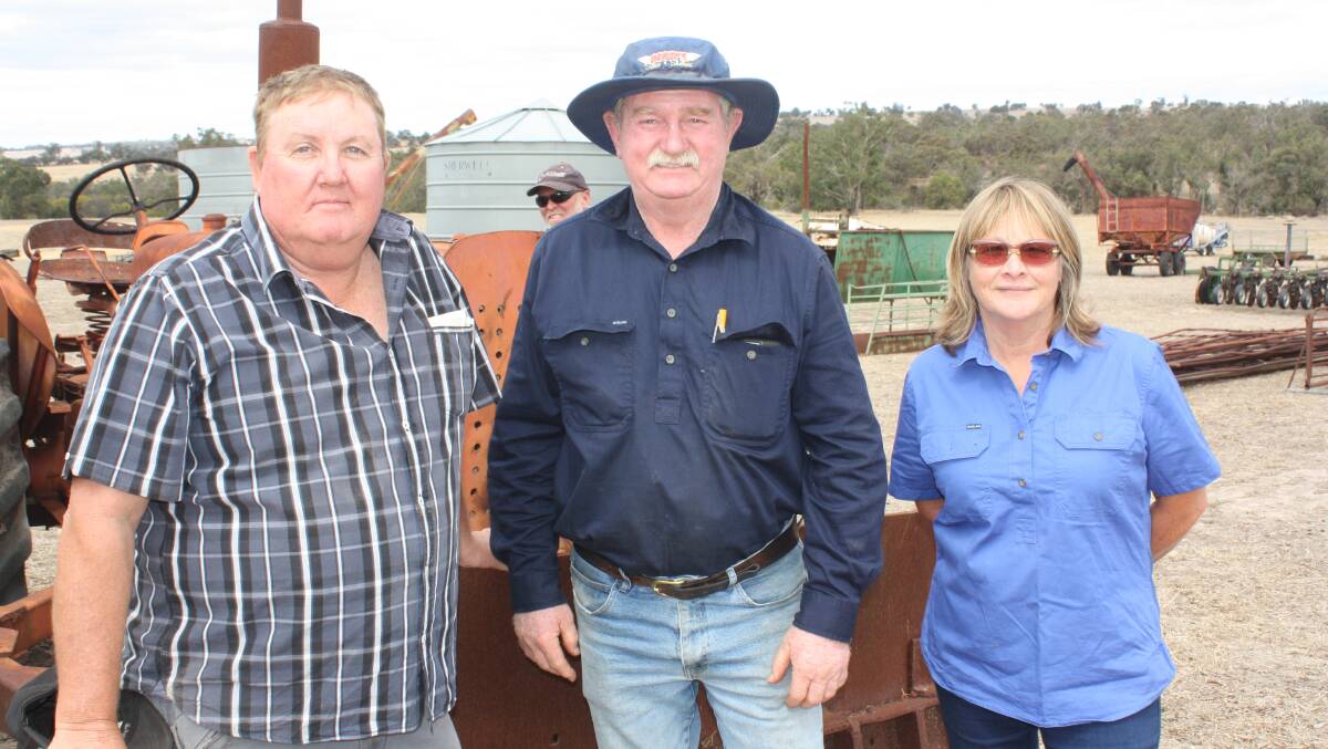  Ian Bailye (left), Rockingham and Paul and Kathy Durack, Kojonup, next to a McCormick International A554 tractor which later sold for $200. "We're neighbours and here to support Jo (Webb)," Ms Durack said.