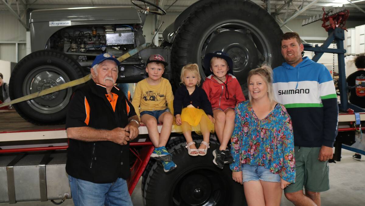 Max Marwick (left), Albany, caught up with his grandchildren Jesse, 5, Cassia, 1, Reef , 7 and their parents Melissa and Josh Button, Albany and showed them his restored 1948 Massey Ferguson TE20, 20 horsepower petrol tractor displayed aboard his 1954 Chevrolet truck.