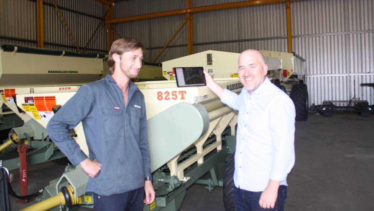 Precision Agronomics Australia field technician Morgan Bailey (left) with Roesner technical director Matt Roesner discussing PAA's i4M apps designed for variable rate product application.