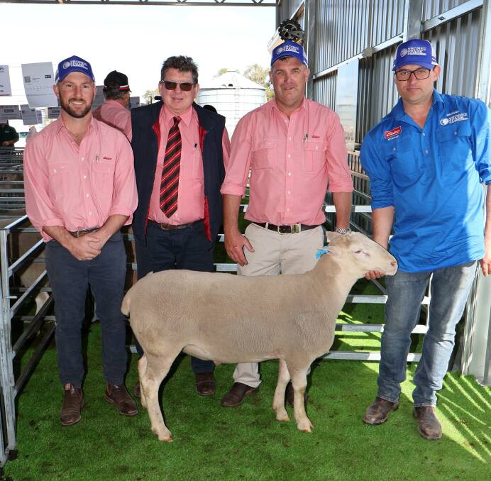 Elders stud stock manager Tim Spicer, Elders stud stock prime lamb specialist, Michael ONeill and Boree Park White Suffolk stud principal Michael Potter, with the $5000 equal top priced ram, purchased by Peter Walker, Jusak stud, Newdegate.