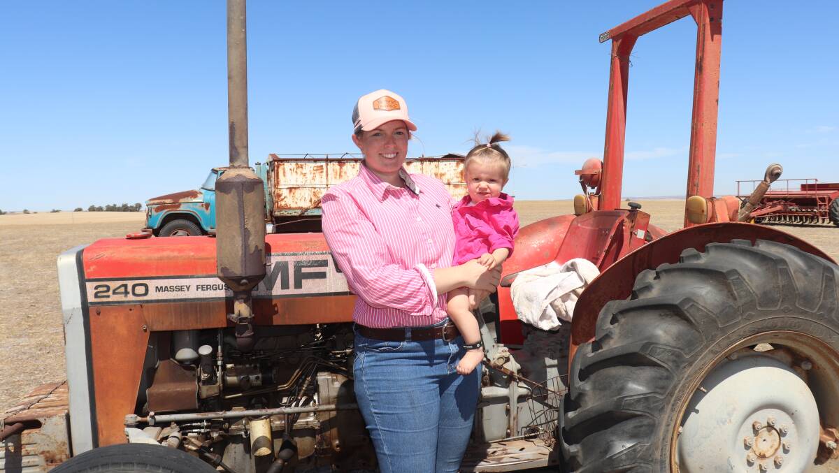 Ayla Pratico and daughter Pamela, eight months, came up from Boyup Brook for the clearing sale. The old Massey Ferguson 240 tractor later sold to a Perth trader after a bidding dual which took the price from $3000 to $5200.