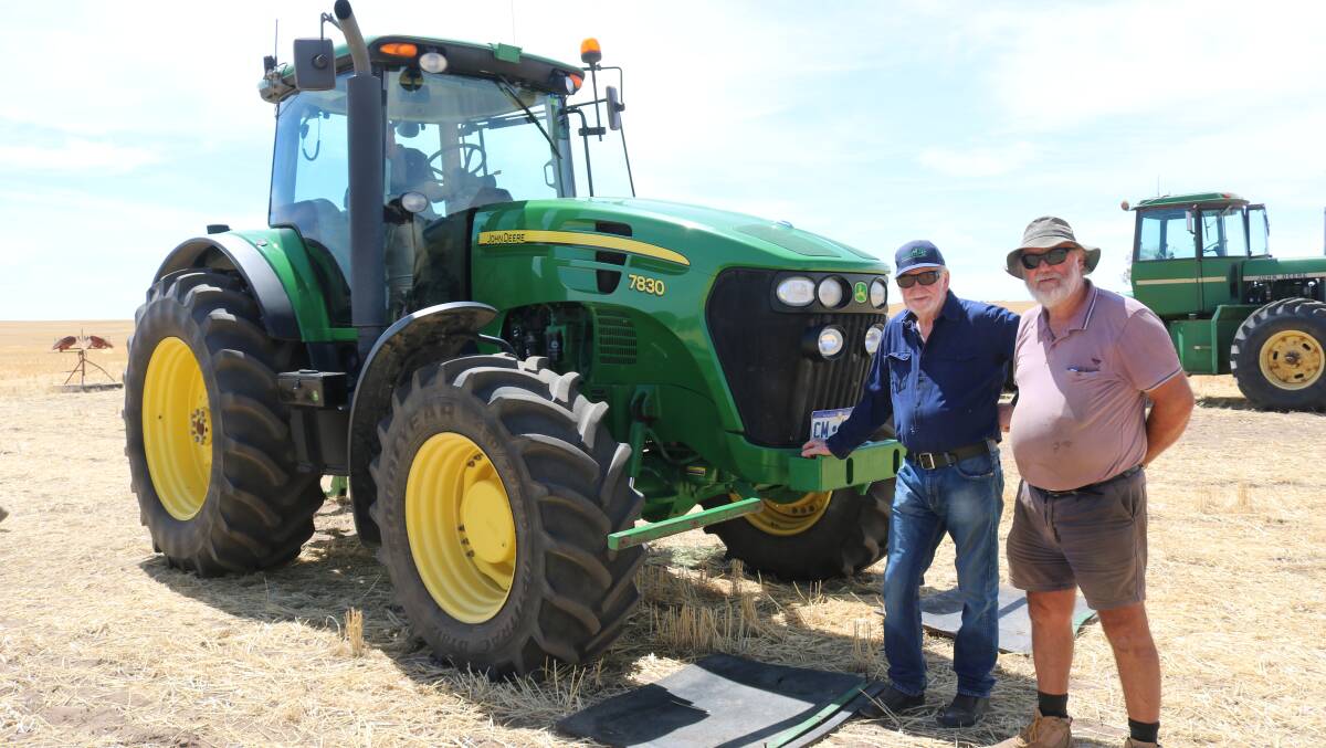 Neighbours Tony Kerkvliet, South Doodlakine and Murray Clement, Kellerberrin, checked out the 2009 John Deere 7830, which sold for $97,000.
