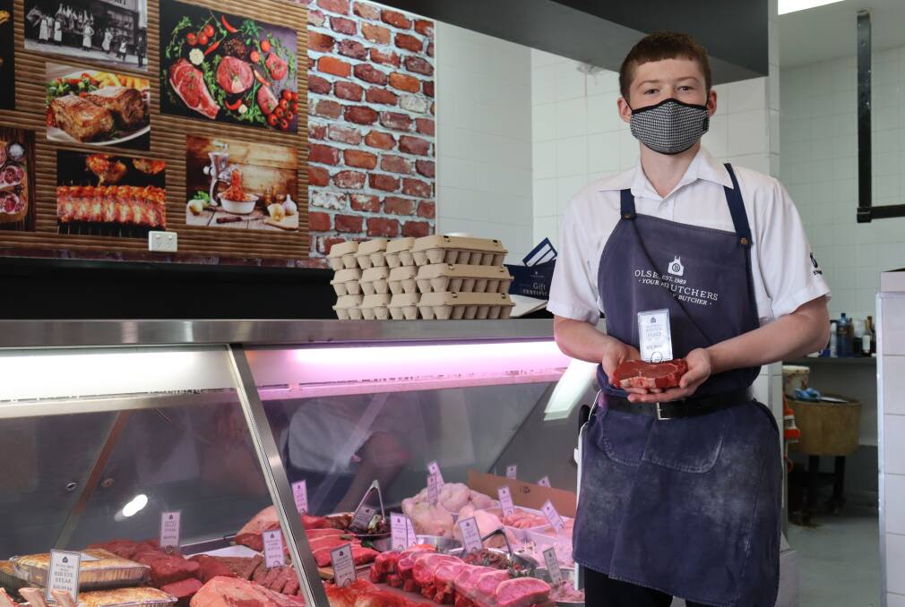 Olsen Butchers apprentice butcher George Binen. Olsen Butchers has been forced to increase red meat prices by 25 per cent over the past two years, but despite this the appetite for beef and lamb has remained strong.
