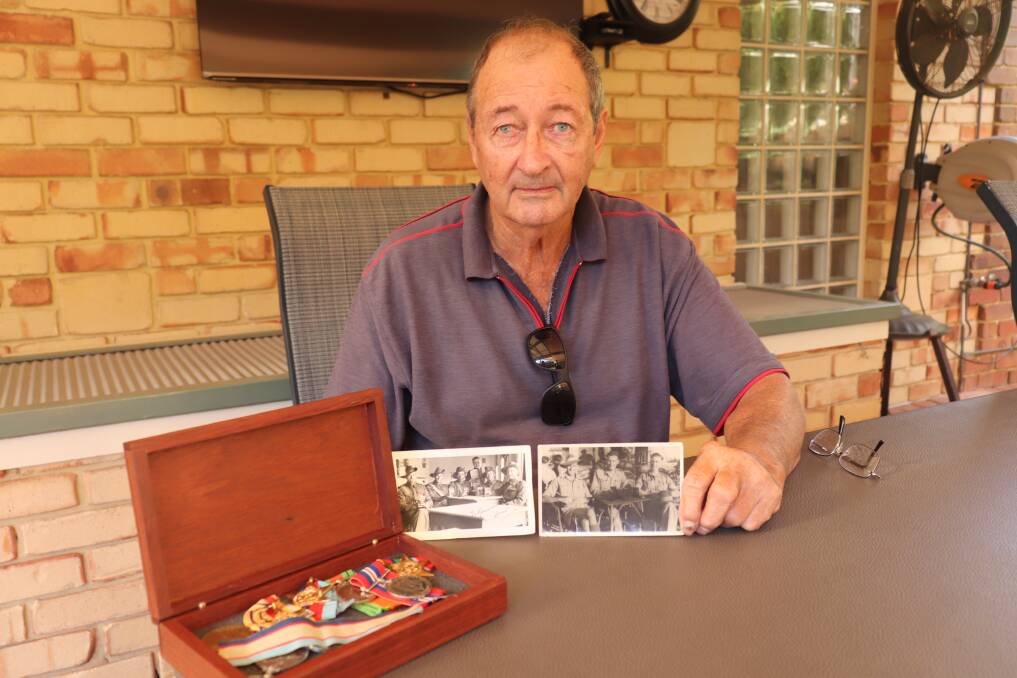 Retired Yelbeni farmer John Marchant with two photographs his father, Private William Alfred 'Bill' Marchant of the 2/28th Infantry Battalion signals platoon, sent back to Western Australia from the Western Desert campaign of World War II. His father's medals are in the wooden box.