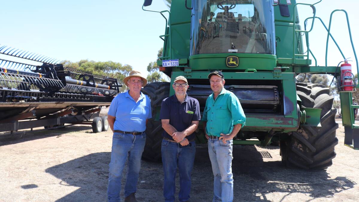 George Fulford (left), Ken Earnshaw and Shane Butterworth, all from Katanning, kicked a few tyres and checked out the miscellaneous lots but did not bid on the 2005 John Deere 9760 header behind them, with 4734 engine hours and 3358 rotor hours, which came with a 12 metre MacDon D60 front and trailer. It was passed in at $30,000.
