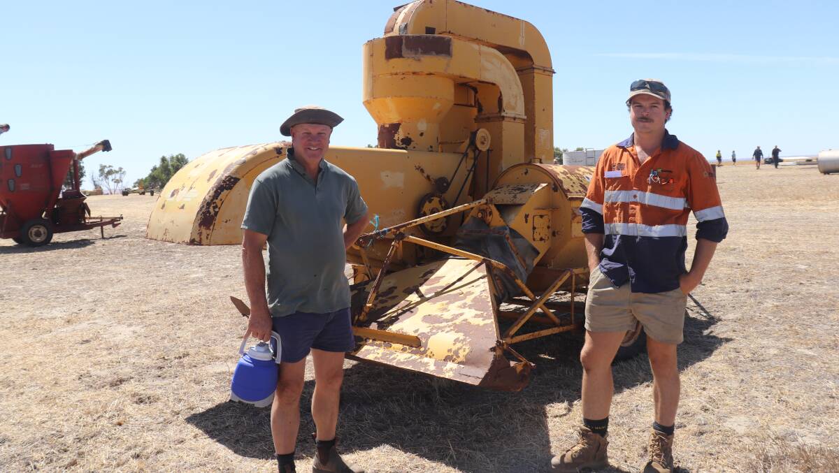  Father and son, Rohan (left) and Kaiden Johnston, Quairading, with a vintage Horwood Bagshaw clover harvester that are still sought after. It sold later for $700.