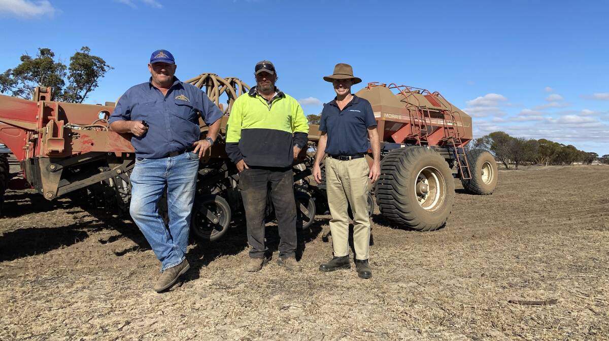 Driver Kevin Turner (left) and Rohan Crombie, Babakin, discuss the Morris seeding cart with Duncan Murdoch, McIntosh & Son.