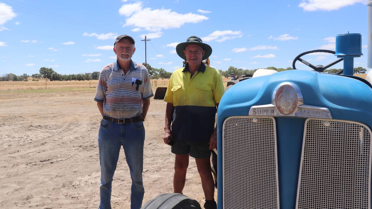 Des Gooding (left), Darkan, with Phil Dicker who worked for the vendors and restored the vintage Fordson Major tractor they are pictured with, after his neighbour spotted it as a garden ornament in his front yard at Doodenanning and asked if he could try getting it going.