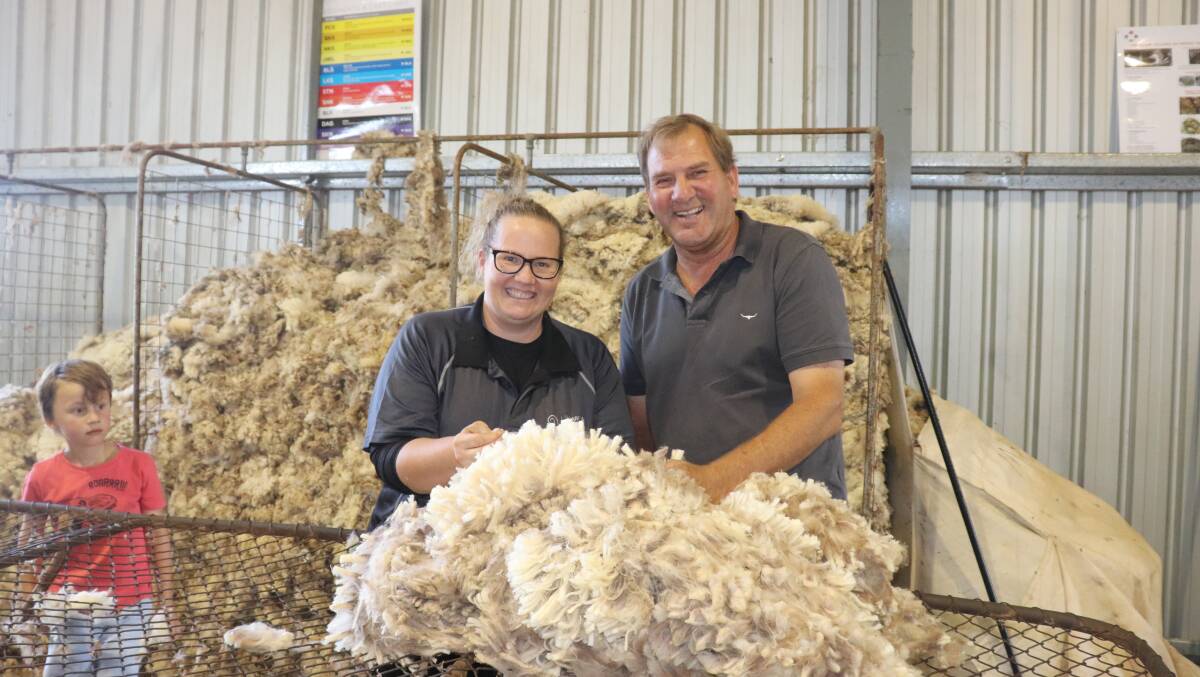 Australian Wool Innovation wool handling trainer Amanda Davis has a laugh at the attempt to roll up a fleece by Agriculture MLC Darren West who visited the Nungarin shearing school.