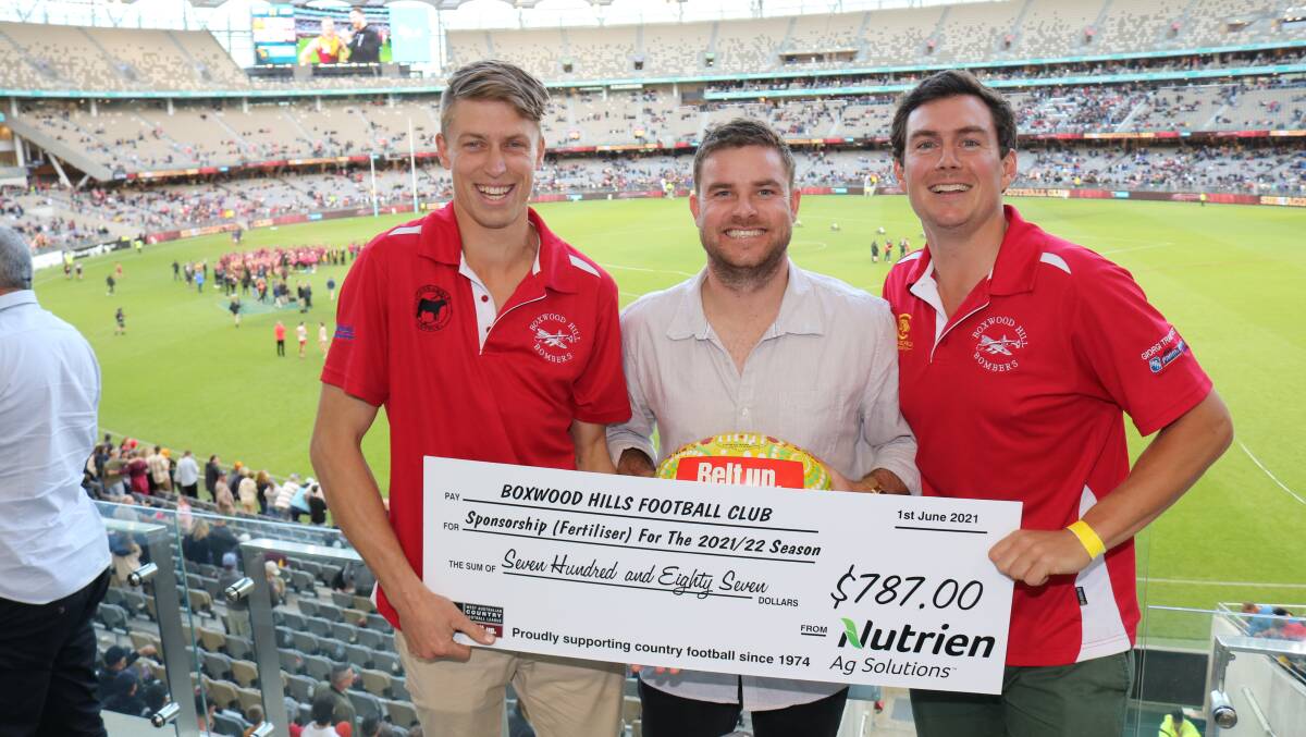 Revelling in the grand final atmosphere and keeping a tight hold on their clubs cheque were Boxwood Hills footballers Rohan Vaux (left) and Edward Moir (right) with friend Gerard Shadbolt, Perth.