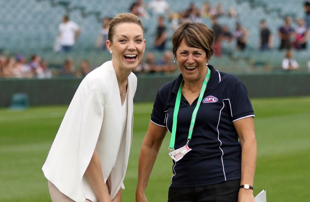 Mia Davies (left) celebrating women's footy with former AFL national female development manager Jan Cooper.