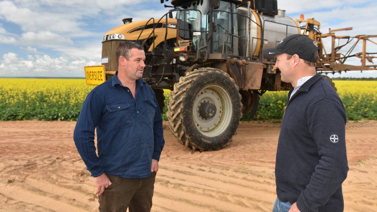 Chapman Valley grower Trevor Piggott (left) and Bayer territory business manager Ty Gronow discuss the application of Aviator Xpro fungicide, which suited the frequent rainfall environment in the northern Wheatbelt last season.