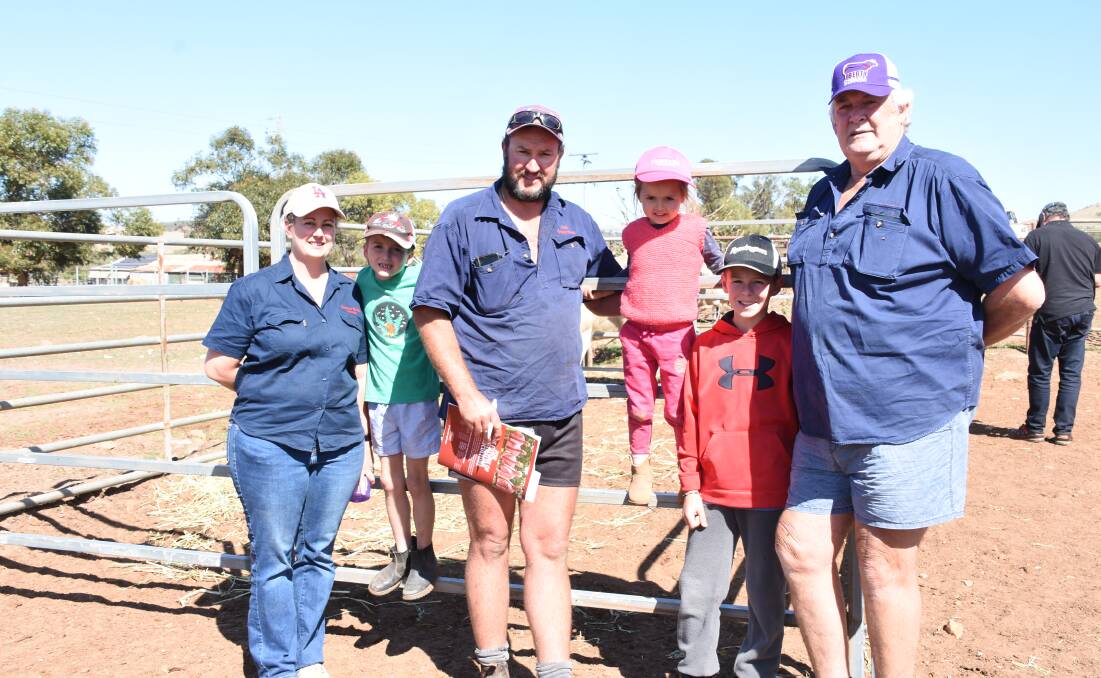 Inspecting the line-up of bulls before the sale was return buyer Matt Couper (centre), Couper Bros, Dowerin, with his wife Kristel and children Mackinley, Violet and David and his uncle James. In the sale the Coupers purchased two Charolais bulls at $11,500 and $7000.