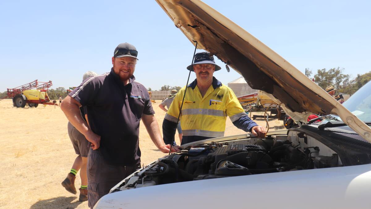 Michael Martin (left) and his father David, both of Williams, looking under the bonnet of a 2001 Toyota HiLux 4x4 single cab ute that sold for $6000.