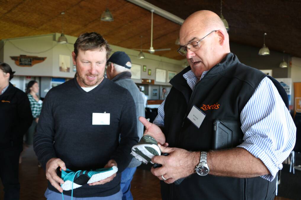  ASHEEP committee member Scott Welke, Cascade (left), and Ben Fletcher from Zoetis admiring the Athletic Propulsion Labs running shoe made with 80 per cent Australian Merino wool.