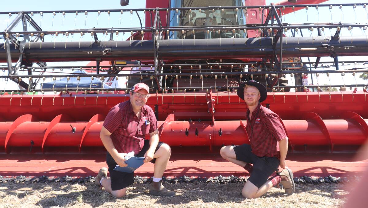 Andrew Boekeman (left) from the Northam dealership and Tristan Job from the Wongan Hills dealership, in front of the Case IH 8250 Axial Flow harvester with 12.5 metre Varicut rigid front.
