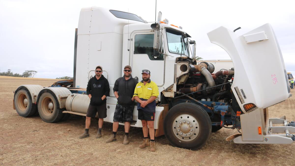  Matt Noakes (left), Brett James and Daniel Bird, all Wickepin, with the 1998 Kenworth truck that sold for $51,000.