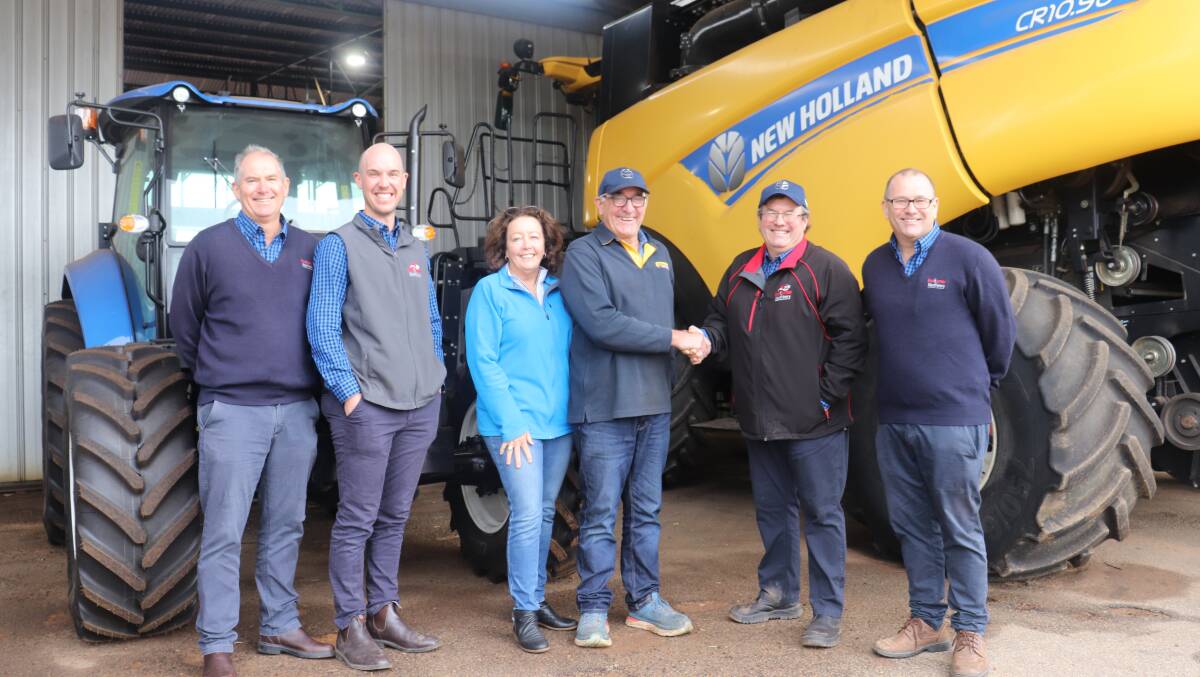 Christine and Barry Coote (centre), owners of Coote Motors, Brookton, hand over to new Boekeman Machinery Brookton branch manager Andrew Boekeman (second right). With them are Boekeman Machinery dealer principal Stuart Boekeman (left), his son Ben and Tim Boekeman.