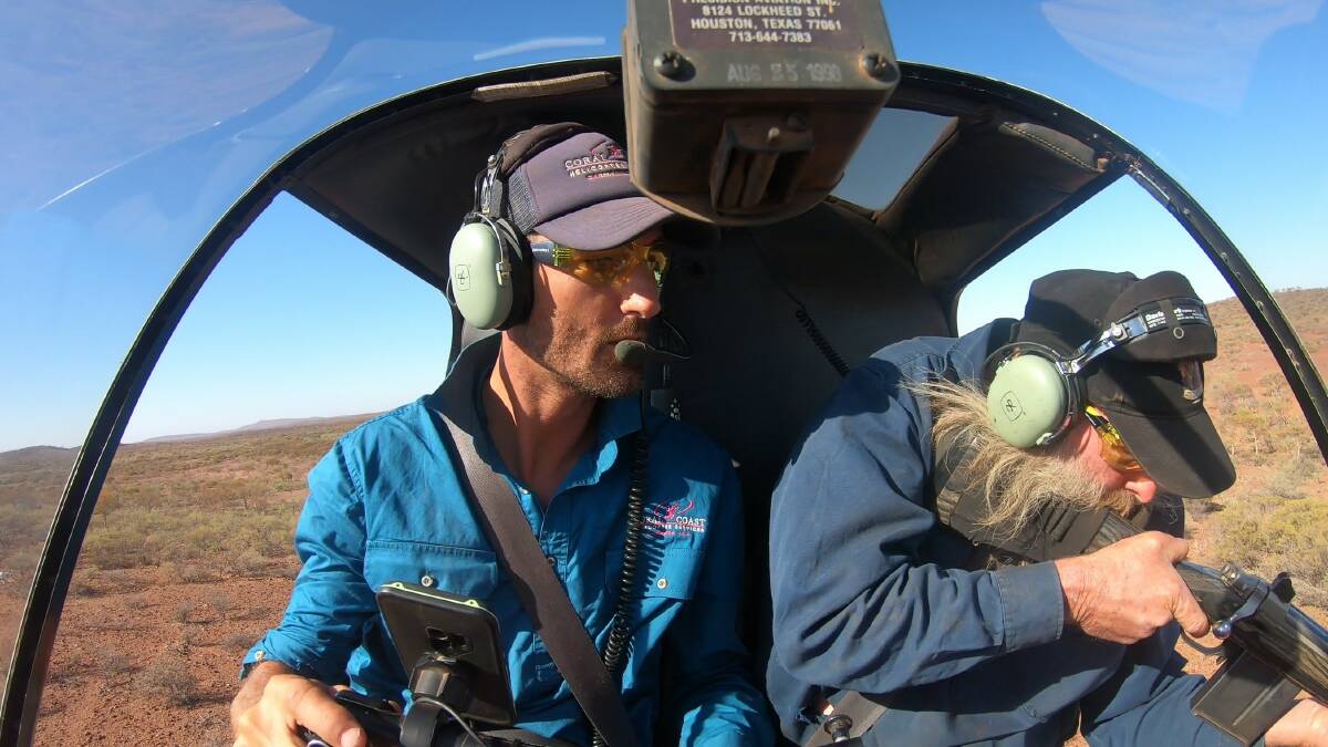 Coral Coast Helicopter Services, CEO and chief pilot, Justin Borg (left), with marksman Peter Mahony in the R22 helicopter tracking and culling pests.