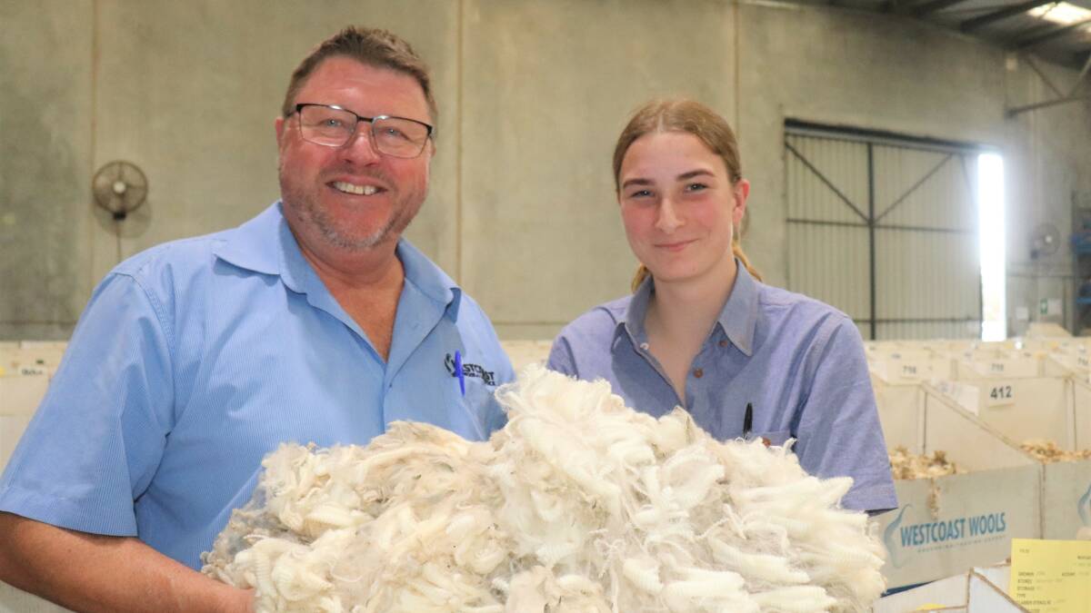 Director and auctioneer Brad Faithfull with work experience student Megan Nekel, 16, Denmark, inspecting wool samples on the show floor at Westcoast Wool & Livestock.
