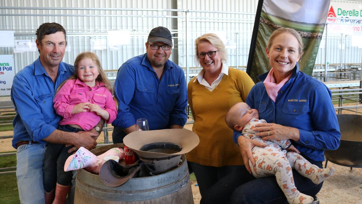 Relaxing after their purchase of six Poll Merino rams were Dean Wormald (left), Hamilton Downs, Munglinup, with daughter Sophia, 4, German chef and hotel manager Mathias Berger who has been working at Hamilton Downs for six months, Faye Sanderson, Grass Patch and Gemma Walker with son William Wormald, 11 months.