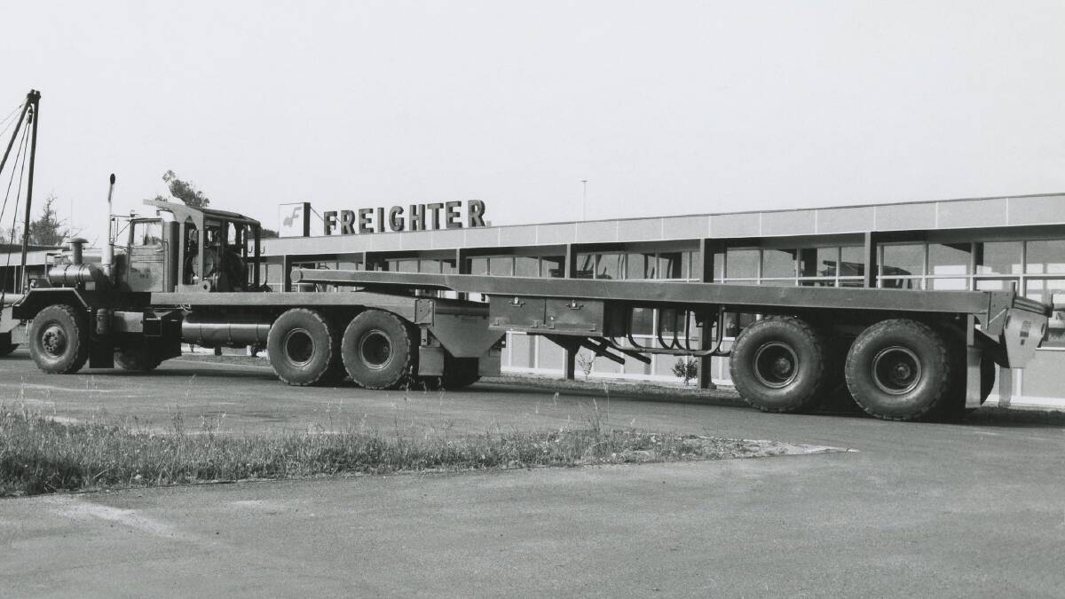 Pictured in front of the Freighter offices, this tandem axle flat top Freighter trailer is ready for a customer delivery. Photo circa 1960s.
