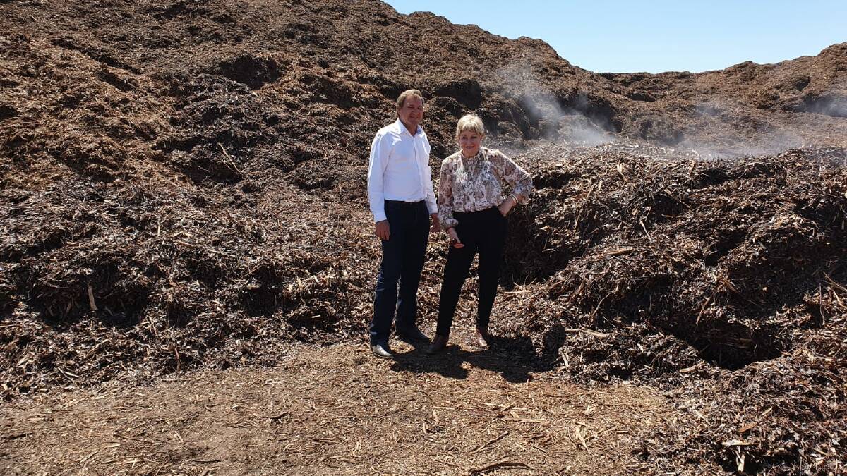 Agriculture Region MLC Darren West and Regional Development, Agriculture and Food Minister Alannah MacTiernan during a visit to Kochii Eucalyptus Oil's eucy still at Kalannie earlier this year. They are standing in the spent eucalyptus biomass left after oil had been extracted. Kochii is investigating turning it into biochar.