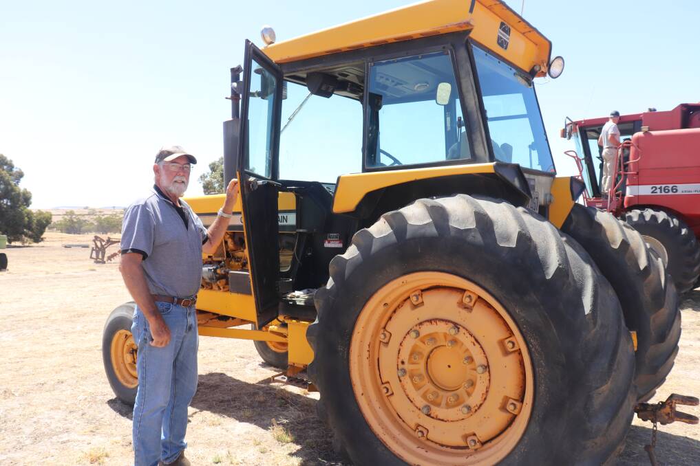 Mike Carthew, Beverley, looks over a Chamberlain 4080B tractor with 6262 hours showing on its John Deere engine. It later sold for $10,000.