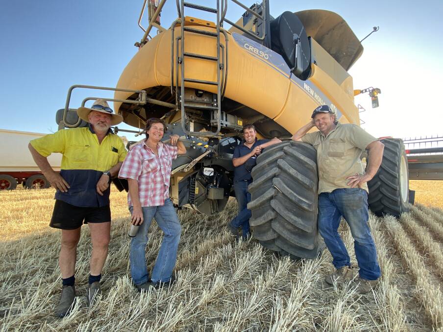Carnamah producers Roger (right) and Angela Dring with farmhand Phil Backman (left) and Matt Howard from McIntosh & Son, Moora, with the Dring family's New Holland CR8.90 combine harvester fitted with the Harrington Seed Destructor (iHSD), purchased last year.